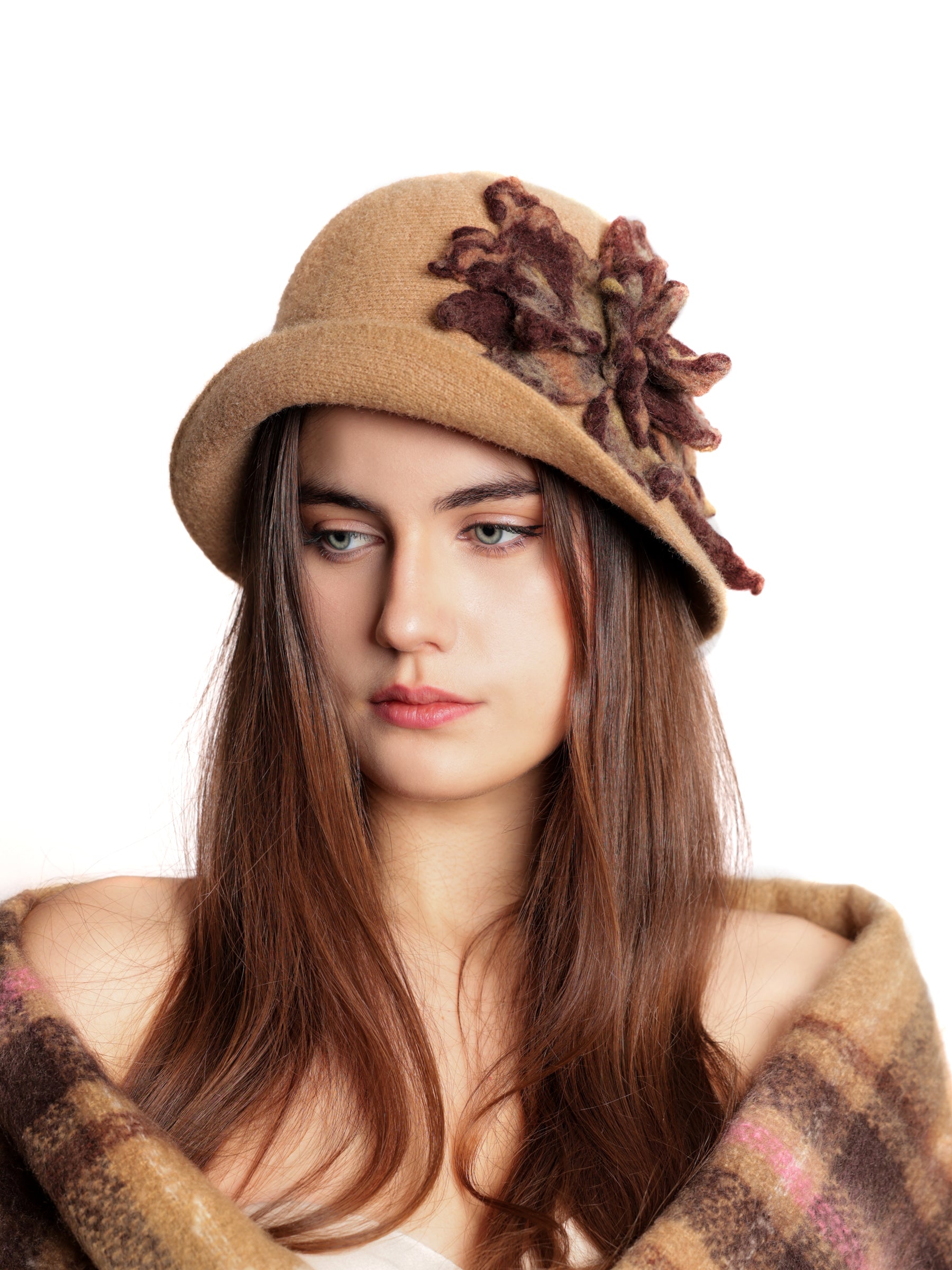 Close-up view of a caramel cloche hat featuring layered handmade wool floral details.