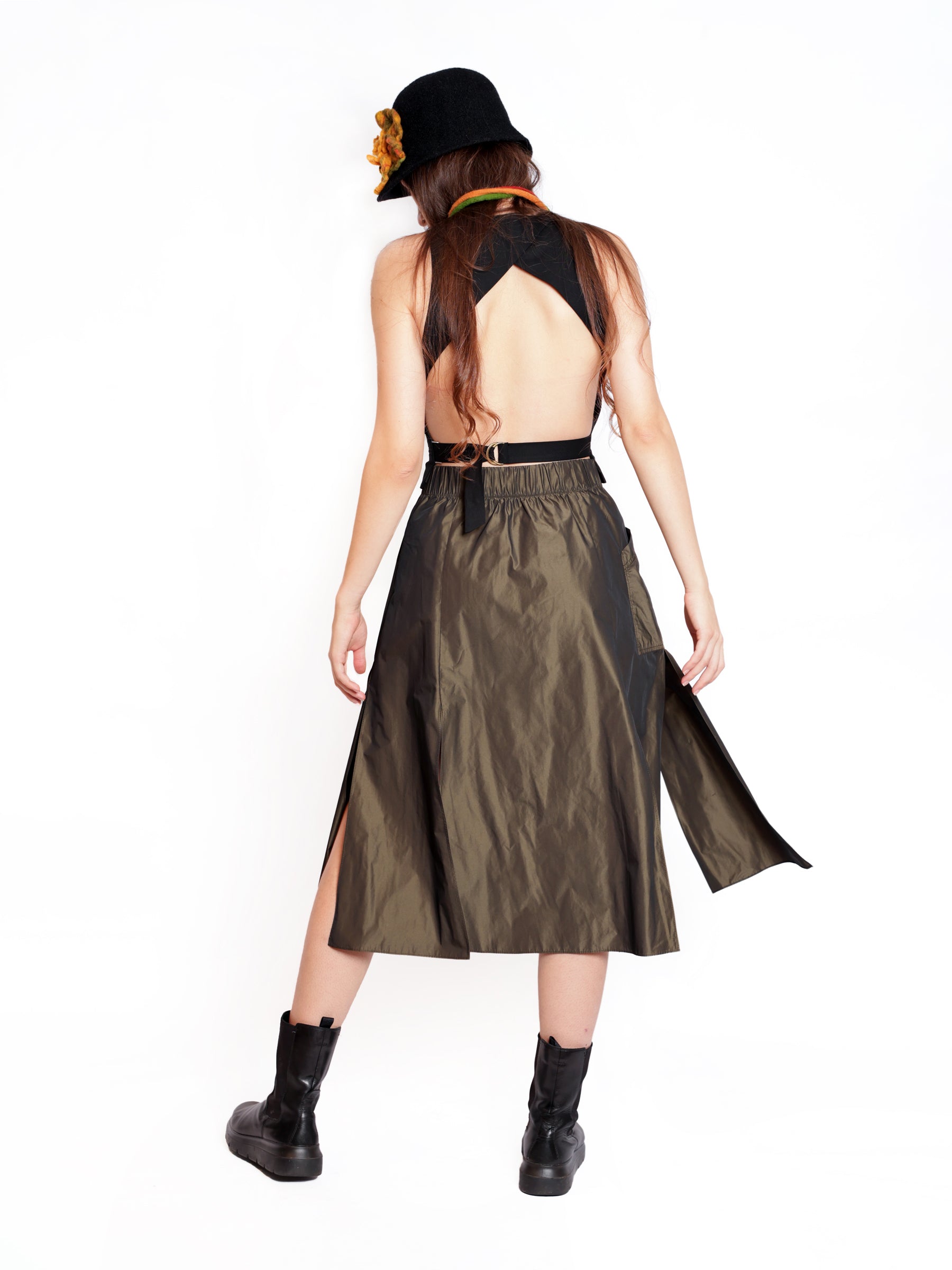 Back view of a women’s metallic bronze midi skirt with clean lines and elegant flow.