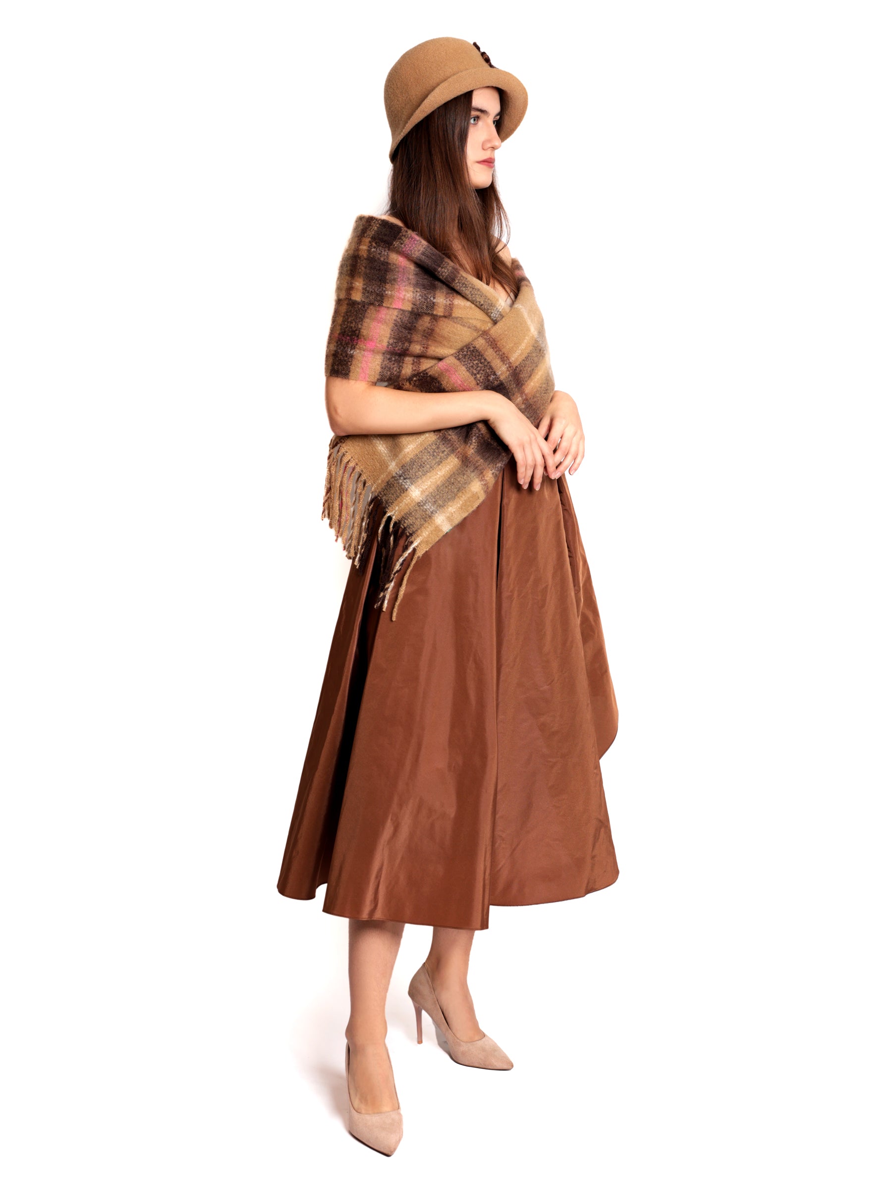 Side view of a woman wearing a brown and copper midi skirt, shown head to toe from the left angle.
