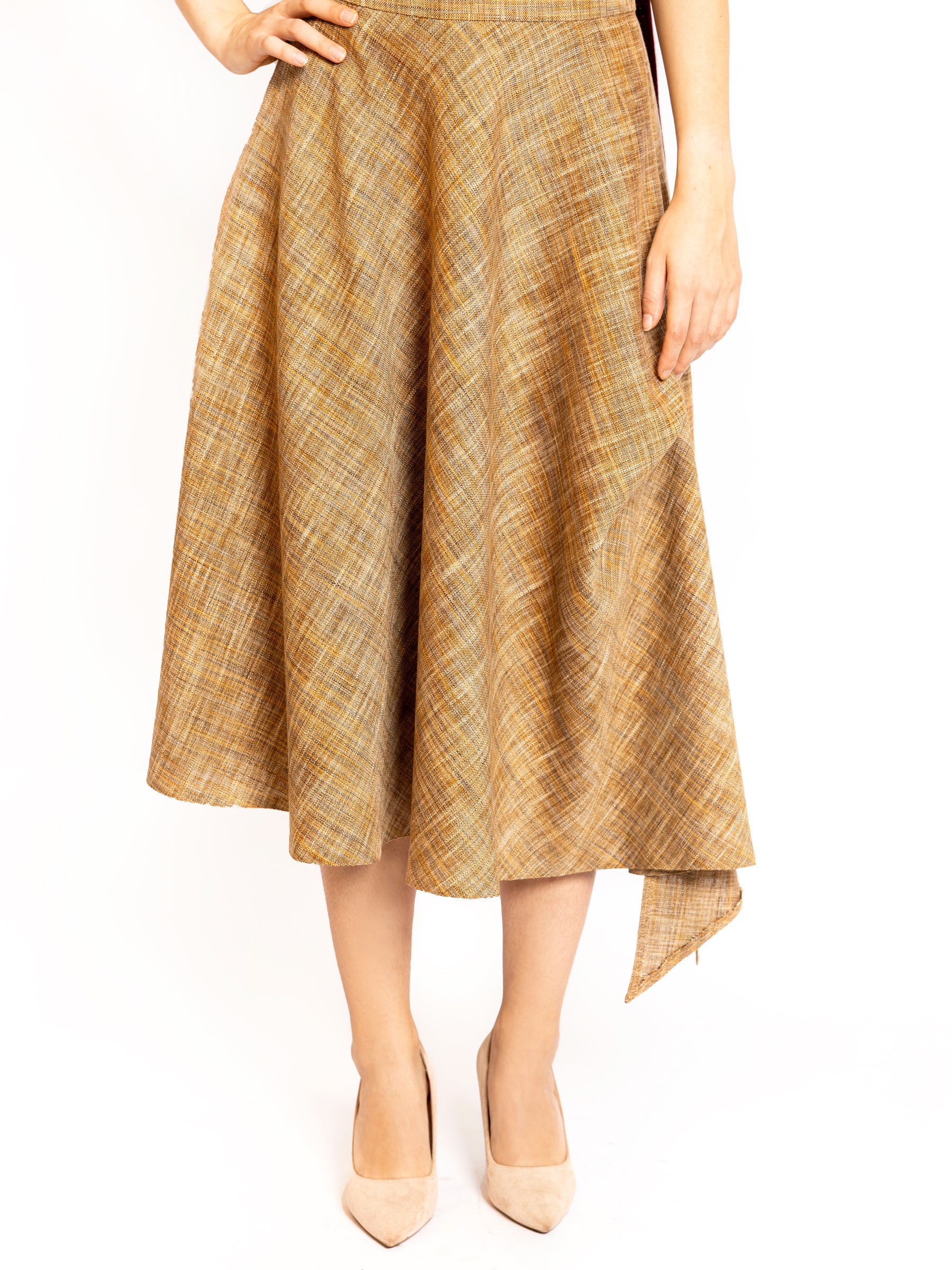 Front view of a camel gold plaid midi skirt shown from chest to toe, emphasizing texture and drape.