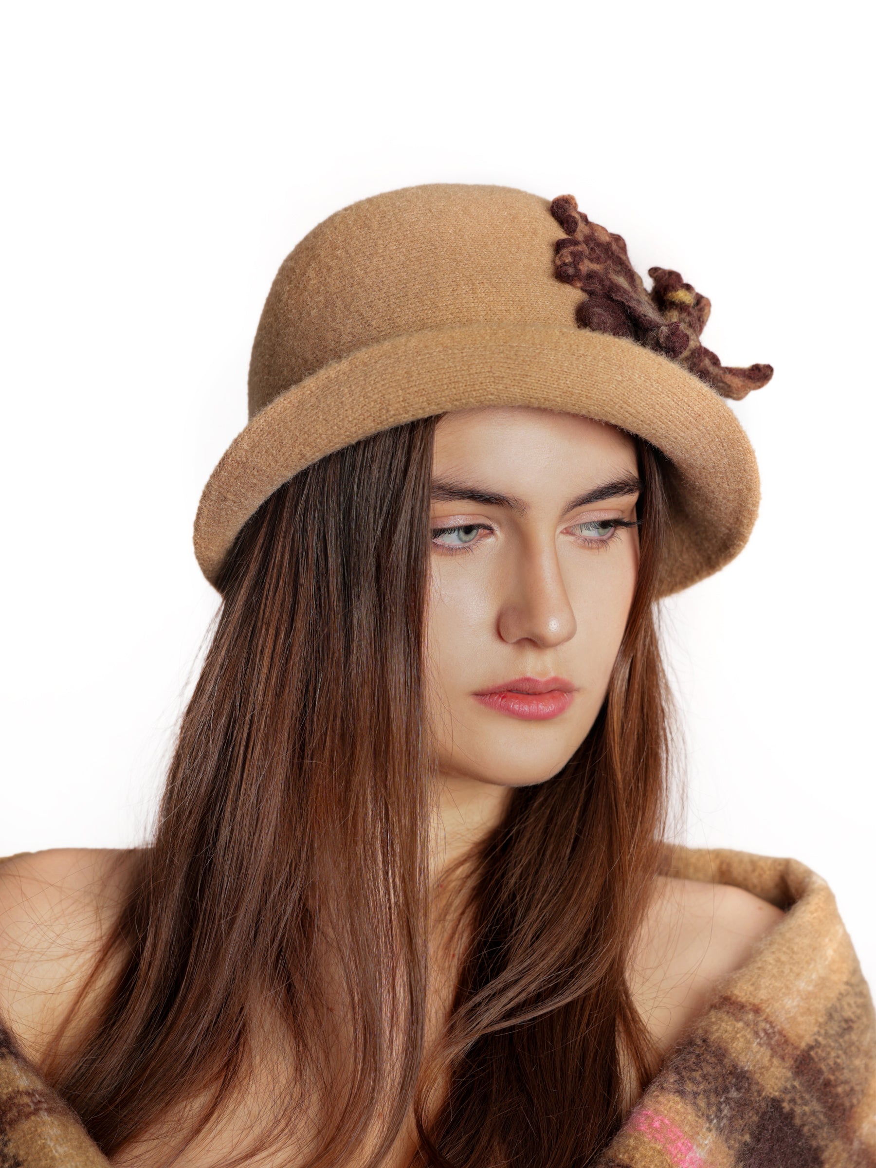 Side view of a cloche hat with brown handmade wool flower and soft textured finish.