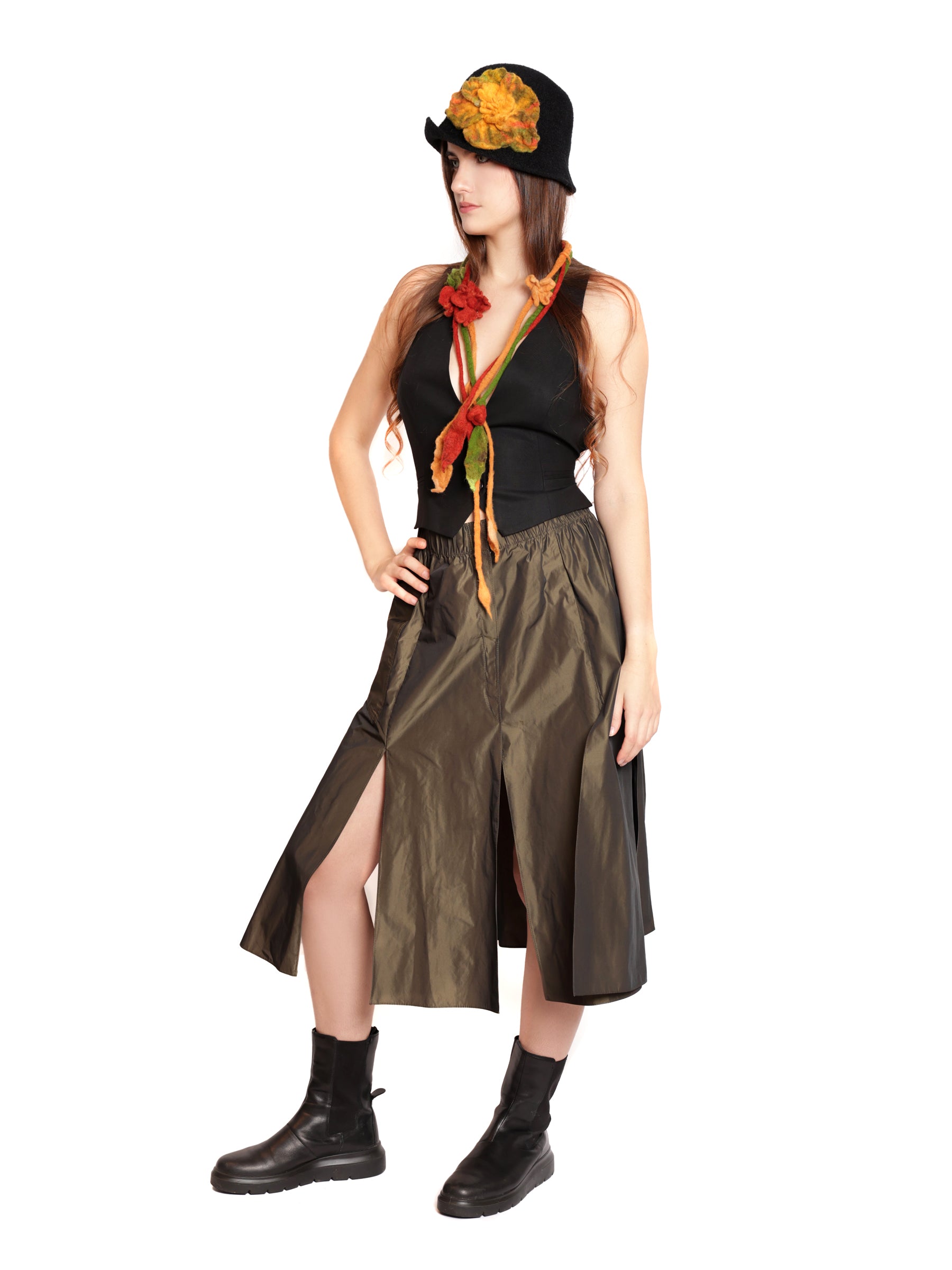 Side view of a women’s bronze midi skirt highlighting its structured drape and subtle sheen.