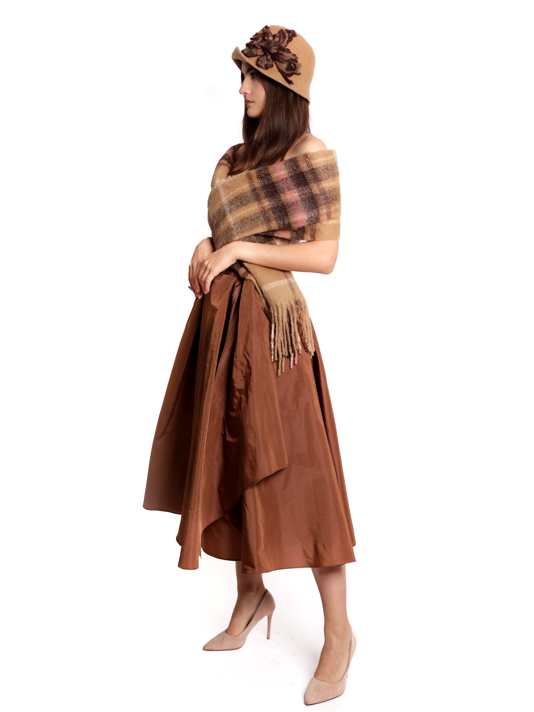 Side view of a woman wearing a copper brown midi skirt, shown head to toe from the right angle.