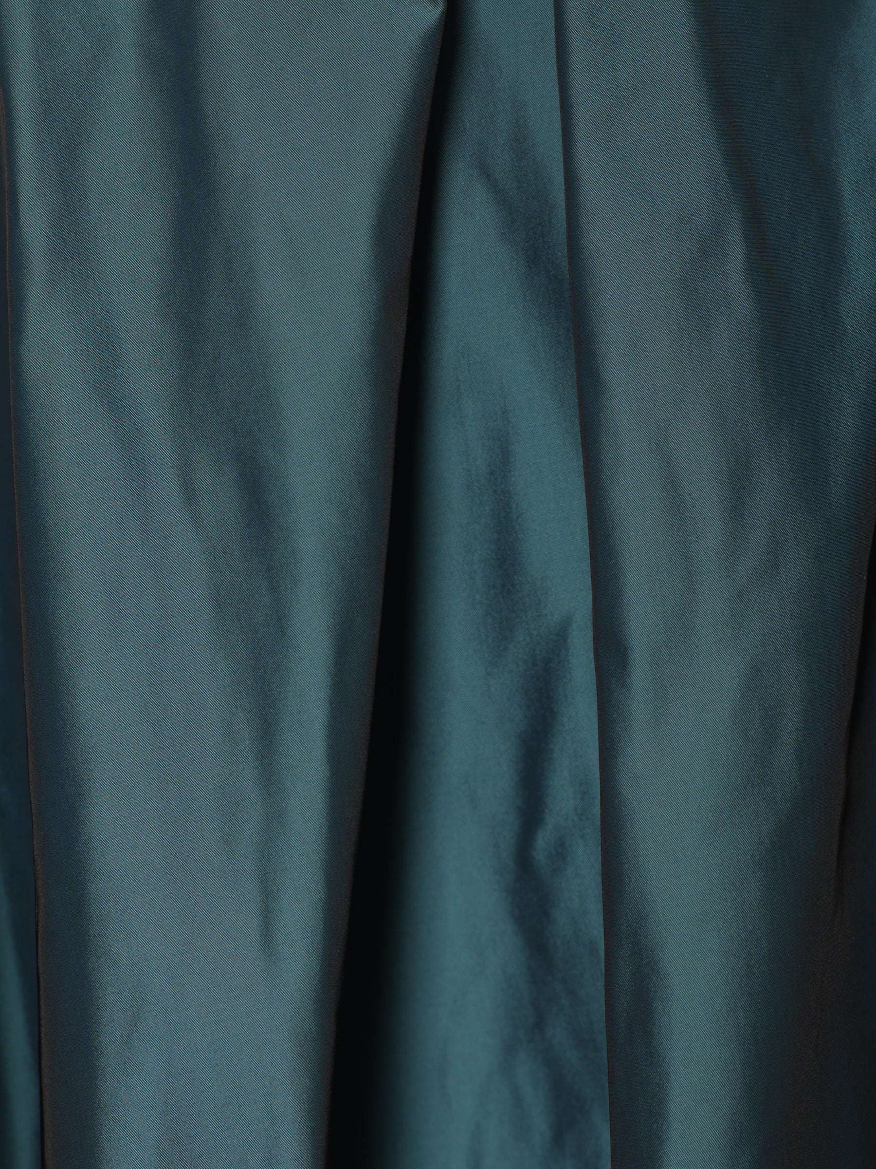 Close-up detail of teal blue woven fabric used in a handcrafted women’s midi skirt.
