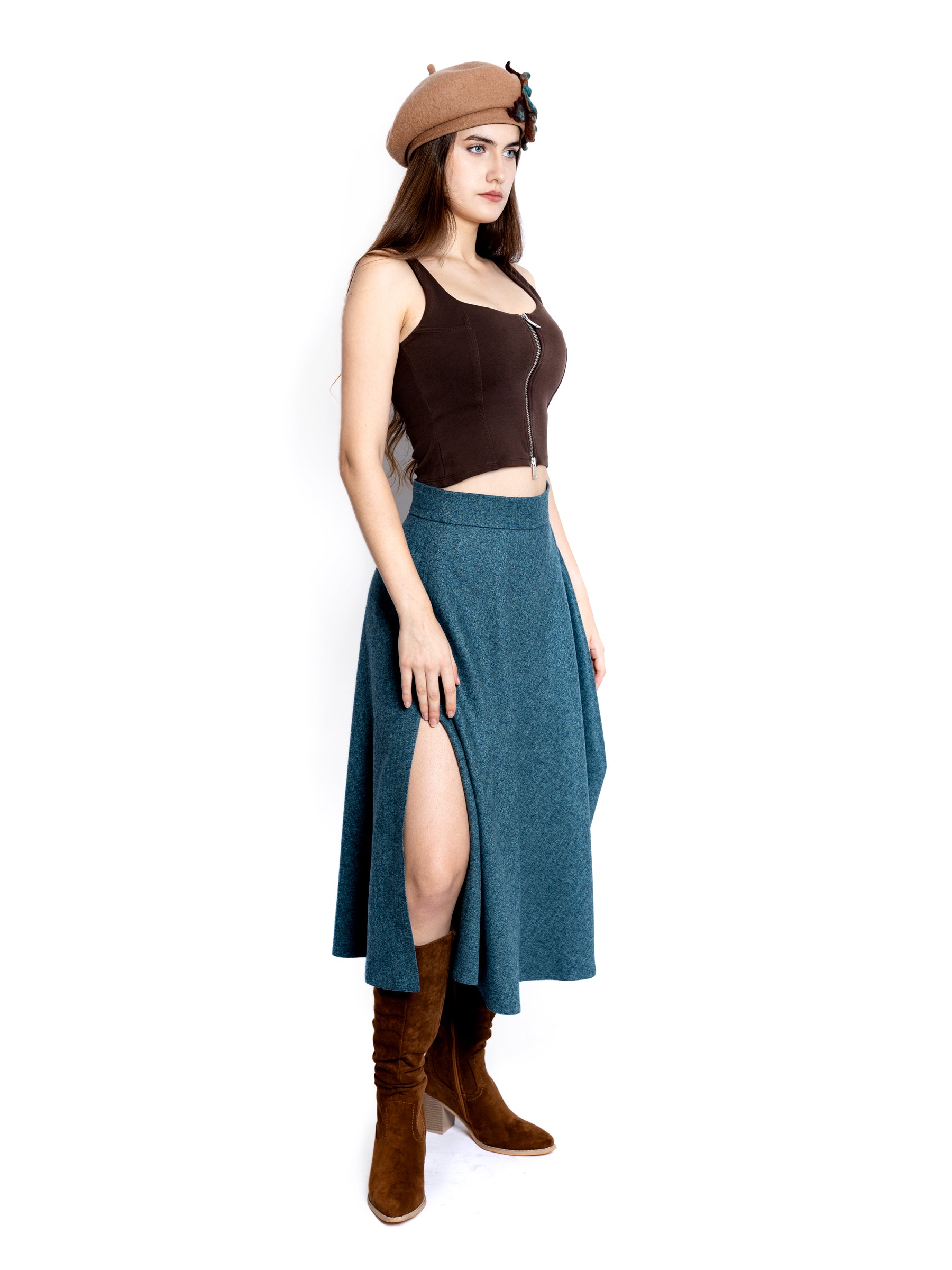 Side view of a woman wearing a handcrafted blue heather midi skirt, shown head to toe.