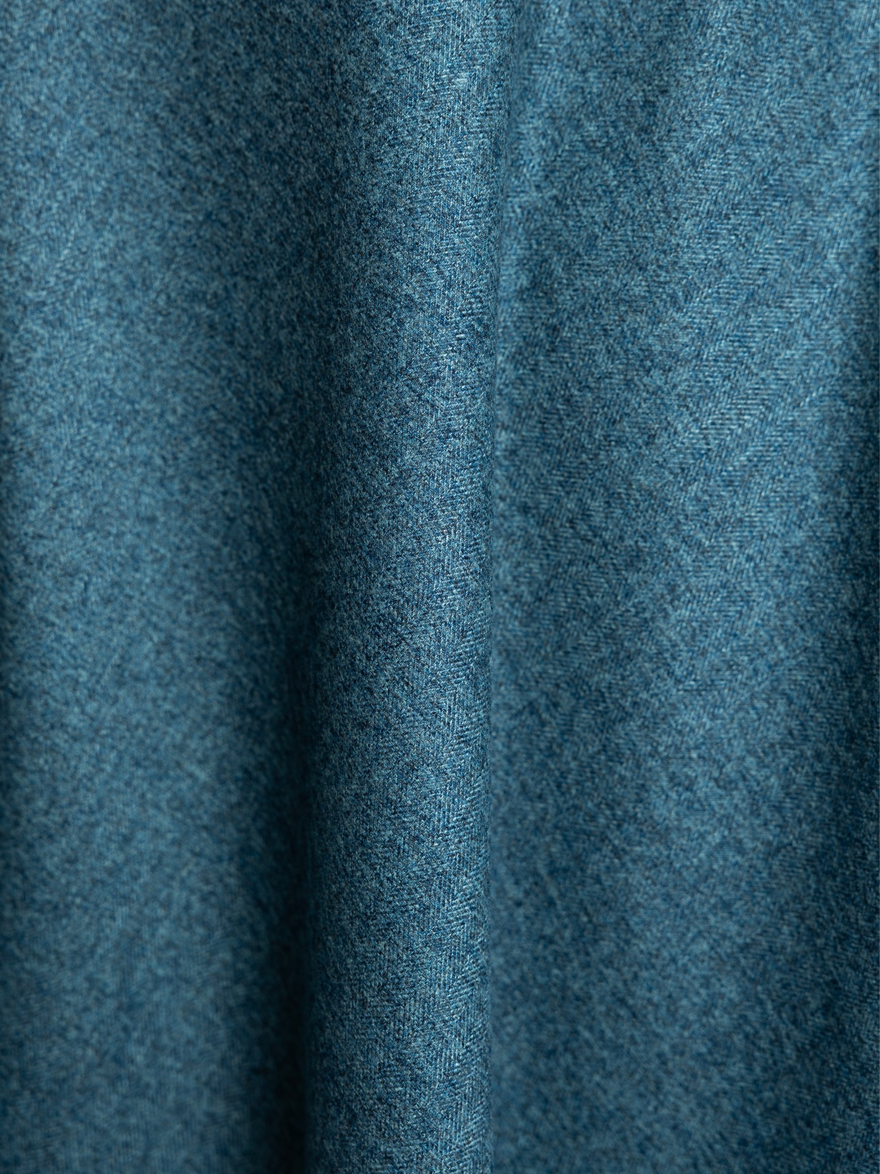 Close-up of teal blue heather fabric used in a handcrafted midi skirt.